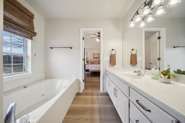 bathroom with vanity, wood-type flooring, and a bathing tub