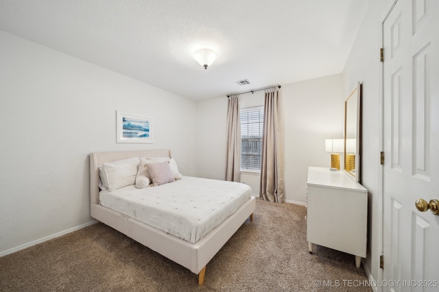 bedroom with carpet and a textured ceiling