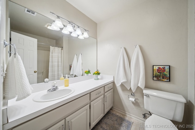 bathroom with vanity, a shower with curtain, and toilet