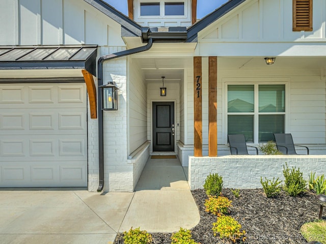 view of exterior entry featuring covered porch