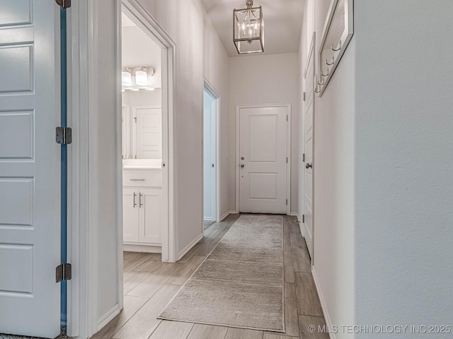 corridor with a chandelier