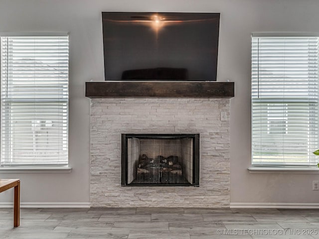 interior details featuring a stone fireplace