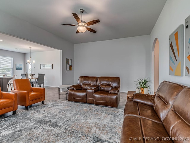 living room featuring hardwood / wood-style floors and ceiling fan with notable chandelier