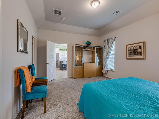 bedroom with a tray ceiling and carpet flooring