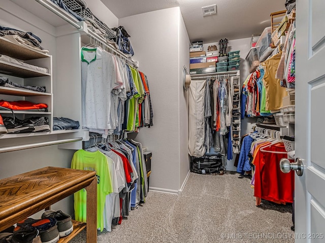 walk in closet featuring carpet