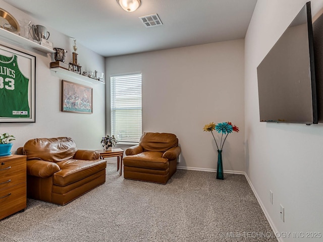 living area featuring carpet