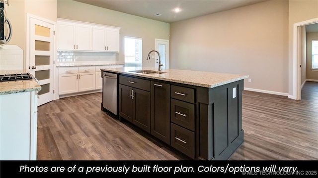 kitchen with sink, white cabinetry, an island with sink, stainless steel appliances, and light stone countertops