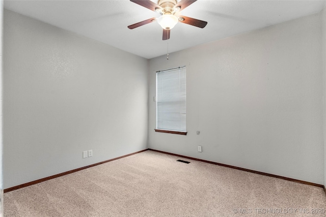 empty room with ceiling fan and carpet flooring