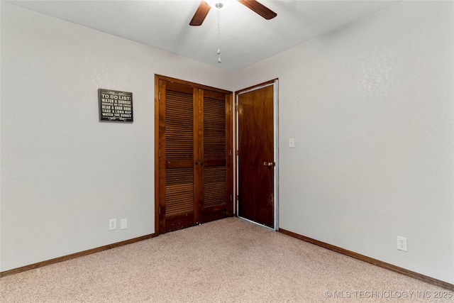 unfurnished bedroom with ceiling fan, a closet, and light carpet