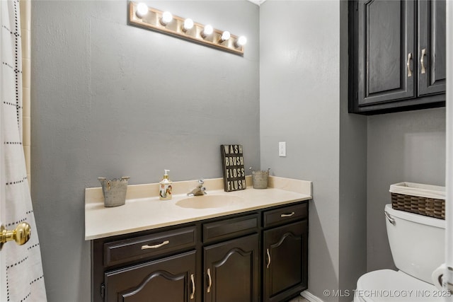 bathroom featuring vanity and toilet