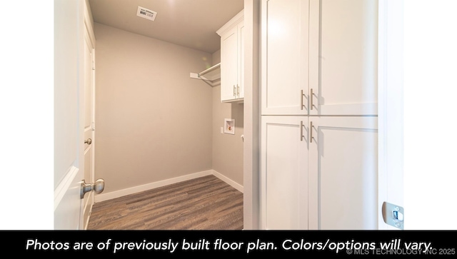 clothes washing area featuring cabinets, washer hookup, and dark hardwood / wood-style floors