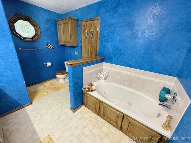 bathroom featuring a washtub, a textured ceiling, and toilet