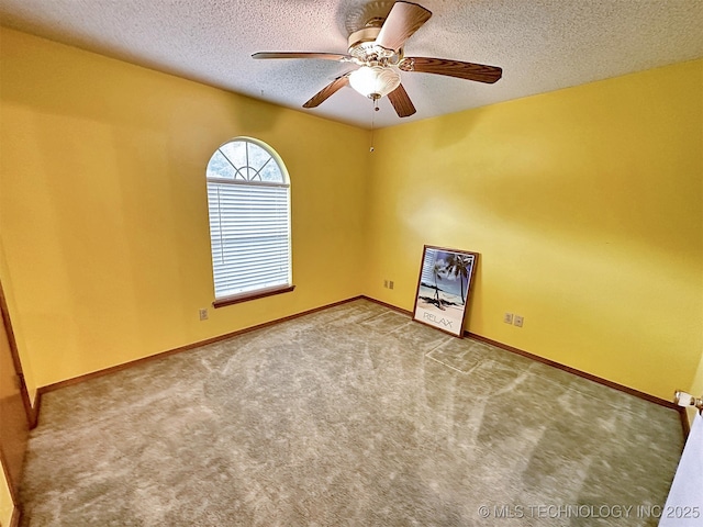 spare room featuring ceiling fan, carpet flooring, and a textured ceiling