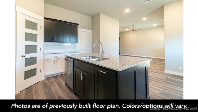 kitchen featuring wood-type flooring, sink, white cabinets, stainless steel dishwasher, and a center island with sink