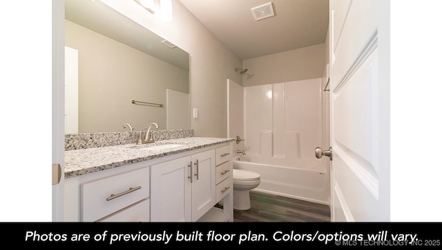 full bathroom featuring vanity, toilet, shower / washtub combination, and wood-type flooring