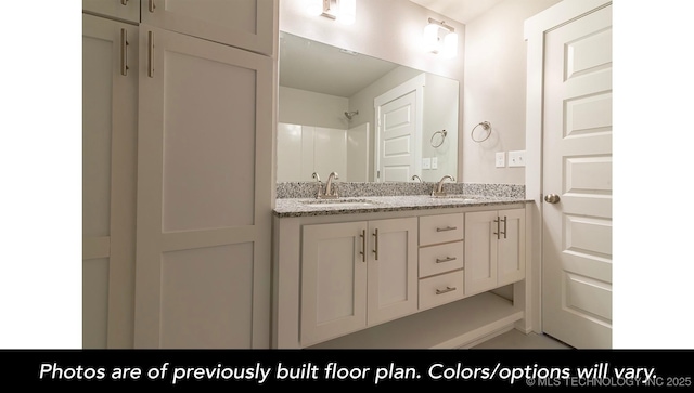 bathroom featuring vanity and a shower