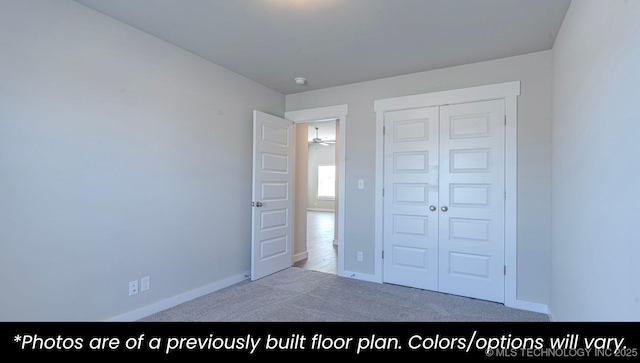 unfurnished bedroom with light colored carpet and a closet