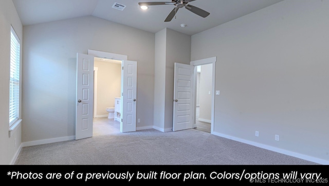 unfurnished bedroom featuring lofted ceiling, light colored carpet, ceiling fan, and ensuite bathroom