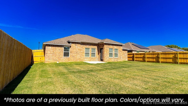 back of house with a patio area and a lawn