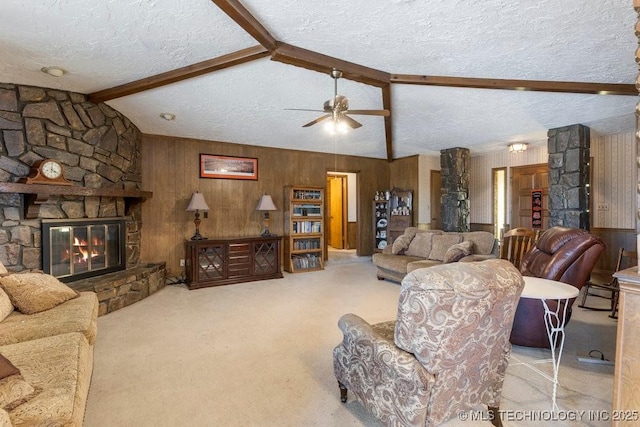 living room with a stone fireplace, wood walls, lofted ceiling with beams, light carpet, and a textured ceiling