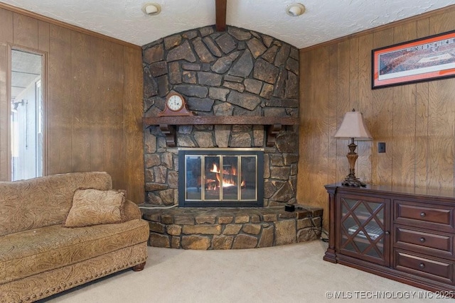 carpeted living room featuring a fireplace, lofted ceiling with beams, wooden walls, and a textured ceiling