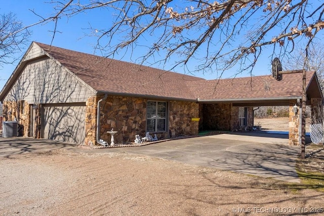 single story home featuring a garage and central AC unit