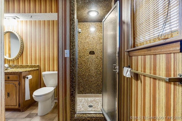 bathroom with walk in shower, vanity, toilet, and tile patterned flooring