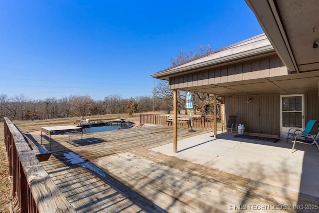 wooden deck featuring a covered pool