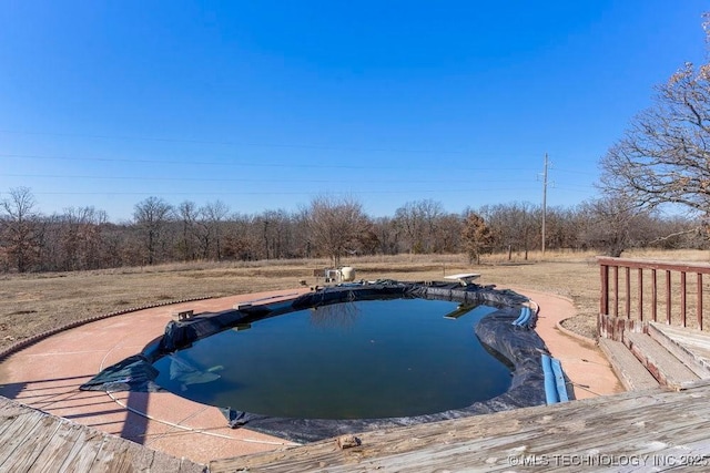 view of pool featuring a diving board