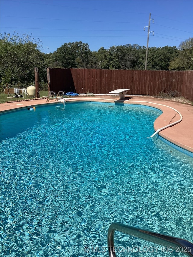 view of pool featuring a diving board