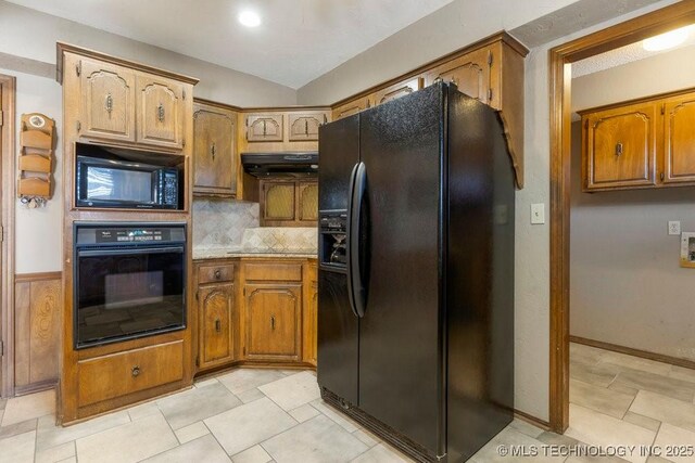 kitchen with ventilation hood, decorative backsplash, and black appliances