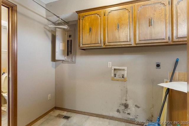 laundry room featuring hookup for a washing machine, electric panel, cabinets, and hookup for an electric dryer