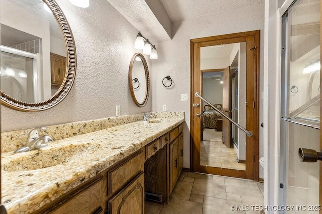 bathroom featuring vanity and a shower with shower door