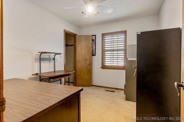 home office with ceiling fan, light carpet, and a textured ceiling