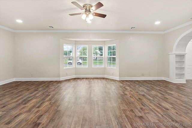 spare room featuring ornamental molding, dark hardwood / wood-style floors, and ceiling fan