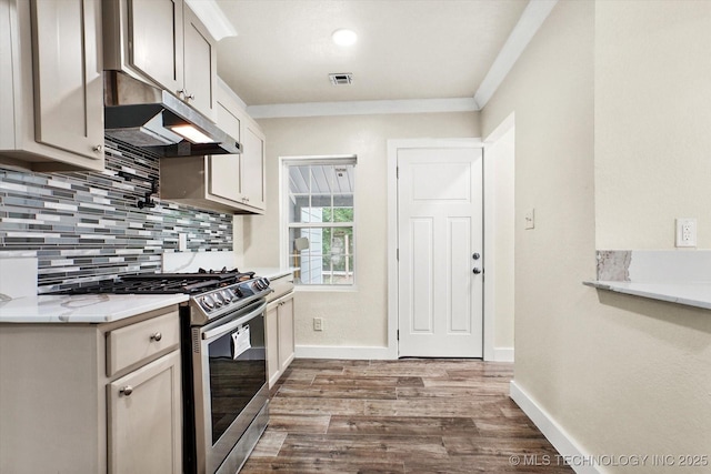 kitchen with hardwood / wood-style floors, stainless steel gas stove, tasteful backsplash, ornamental molding, and light stone counters