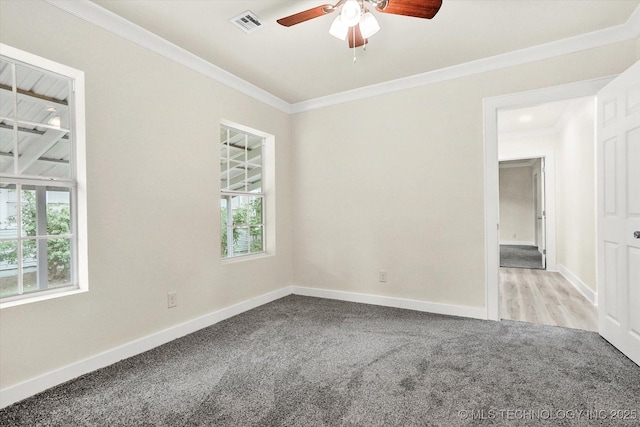 carpeted spare room with crown molding and ceiling fan