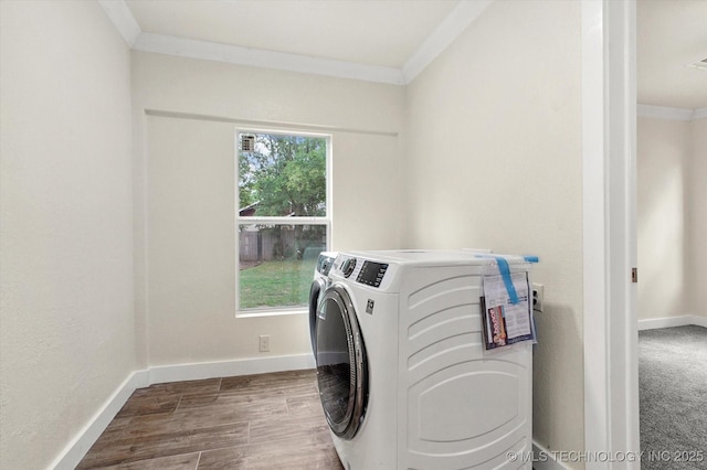 washroom with hardwood / wood-style flooring, ornamental molding, a healthy amount of sunlight, and independent washer and dryer