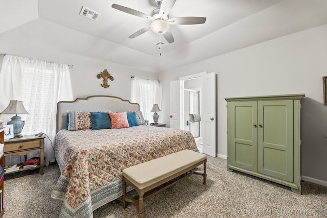 bedroom with ceiling fan, a raised ceiling, and carpet