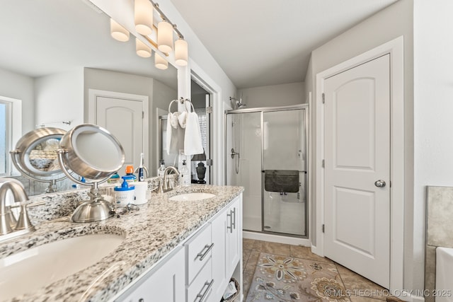 bathroom featuring tile patterned flooring, vanity, and walk in shower