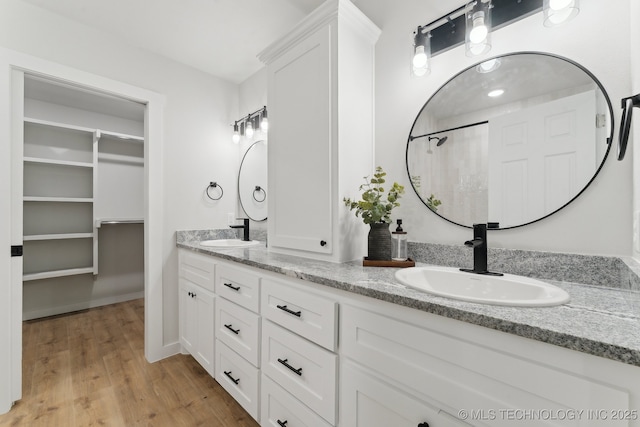 203 W Monroe Ave, Mcalester, OK 74501 - full bathroom with double vanity and wood finished floors