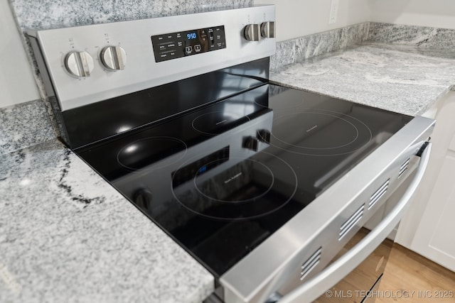 203 W Monroe Ave, Mcalester, OK 74501 - kitchen view of stainless steel electric range and light wood finished floors