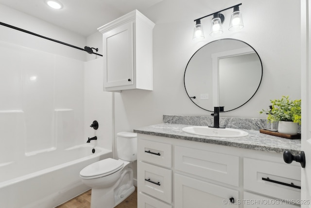203 W Monroe Ave, Mcalester, OK 74501 - full bathroom with vanity, toilet, wood finished floors, and shower / washtub combination