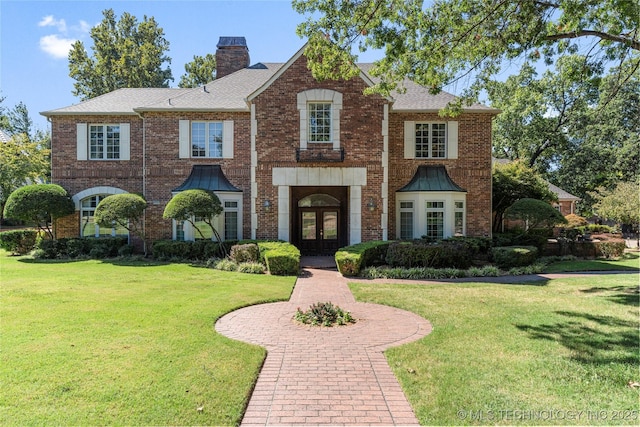 view of front of home featuring french doors and a front lawn