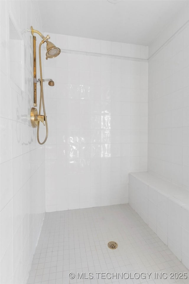 bathroom with tiled shower