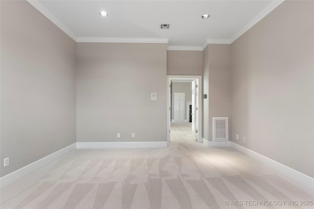 spare room featuring ornamental molding and light colored carpet