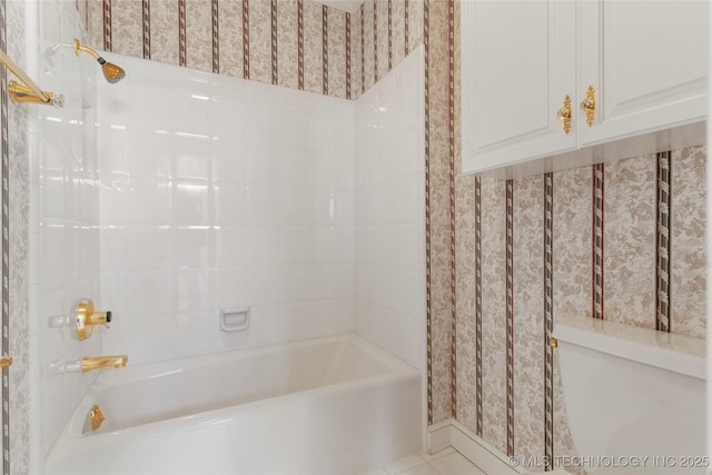 bathroom with tile patterned flooring and tiled shower / bath