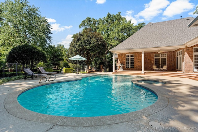 view of swimming pool featuring ceiling fan and a patio area