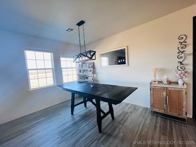 dining room with dark hardwood / wood-style flooring