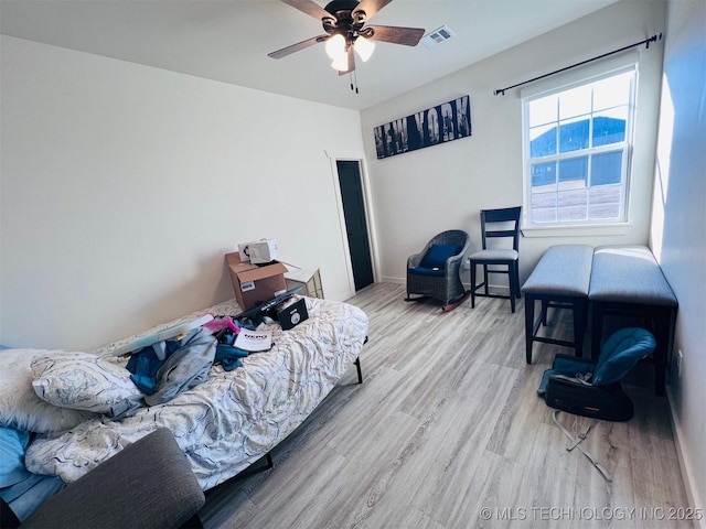 bedroom with ceiling fan and light wood-type flooring